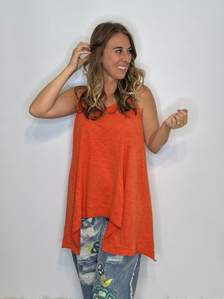 Asymmetrical sleeveless tunic in vintage tangerine, made of soft preshrunk cotton with a flowing, handcrafted look.