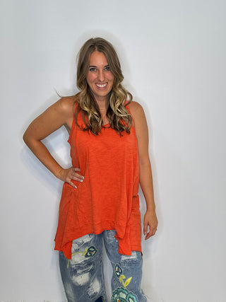 Asymmetrical sleeveless tunic in vintage tangerine, made of soft preshrunk cotton with a flowing, handcrafted look.