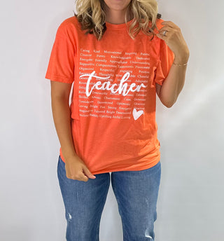 Graphic t-shirt with heart design made of positive teacher words in green and orange with white text. Teachers