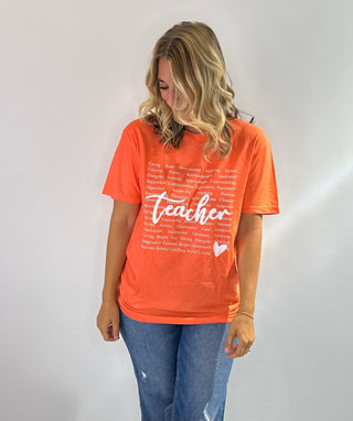 Graphic t-shirt with heart design made of positive teacher words in green and orange with white text. Teachers