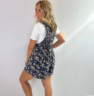 Denim short romper with floral print, v neckline and front pleated detail for a feminine, structured fit. 