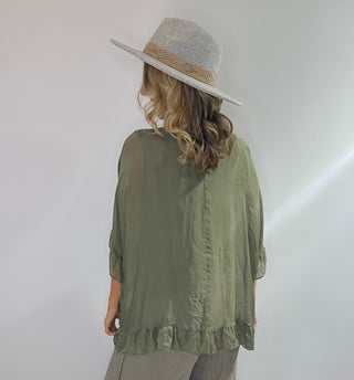 Sage Green oversized silk blouse with ruffle short sleeves, ruffle hem, and back keyhole button closure