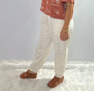 Cream jogger pants with embroidered diamond pattern, elastic drawstring waist and front and back pockets by Jaded Gypsy