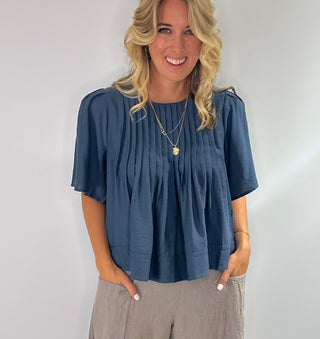 Elegant blue blouse featuring sublet pin tuck detailing across the front