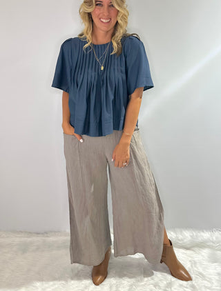 Elegant blue blouse featuring sublet pin tuck detailing across the front