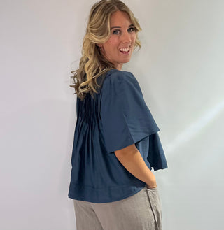 Elegant blue blouse featuring sublet pin tuck detailing across the front