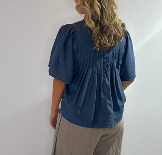 Elegant blue blouse featuring sublet pin tuck detailing across the front
