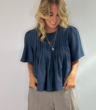 Elegant blue blouse featuring sublet pin tuck detailing across the front