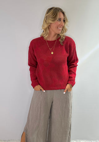 Open weave crew neck sweater with daisy pattern in rust red and taupe colors