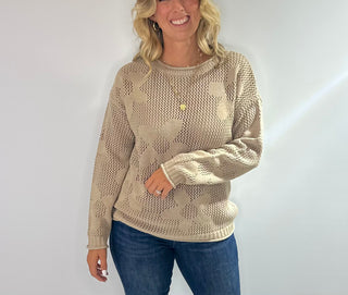 Open weave crew neck sweater with daisy pattern in rust red and taupe colors