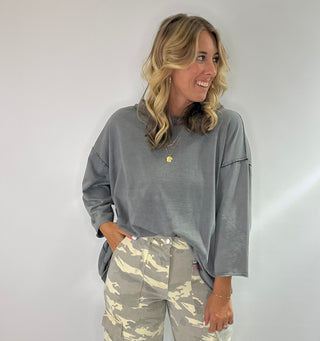 Oversized slate gray cotton top with exposed stitching and 3/4 length sleeve tee