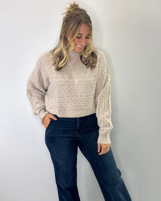 Brushed Marled cable knit cropped mock neck sweater with cozy texture and soft neutral tones. 