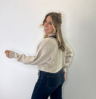 Brushed Marled cable knit cropped mock neck sweater with cozy texture and soft neutral tones. 