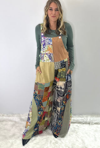 Soft multi-color patchwork jumpsuit featuring mixed fabrics in gentle tones and relaxed wide-leg silhouette