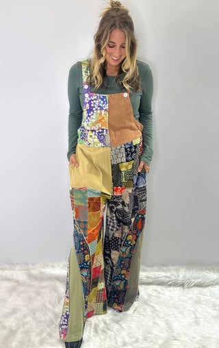 Soft multi-color patchwork jumpsuit featuring mixed fabrics in gentle tones and relaxed wide-leg silhouette