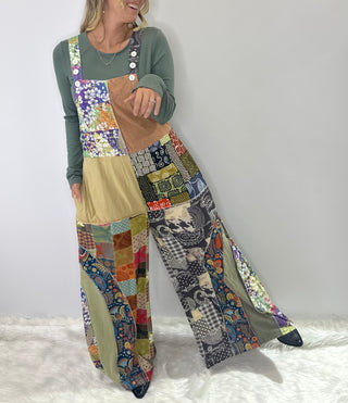 Soft multi-color patchwork jumpsuit featuring mixed fabrics in gentle tones and relaxed wide-leg silhouette