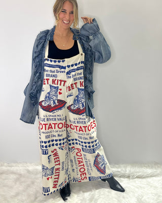 Beige Cotton Jumpsuit with vintage blue and red Kitten brand graphics, adjustable straps and back pockets. 