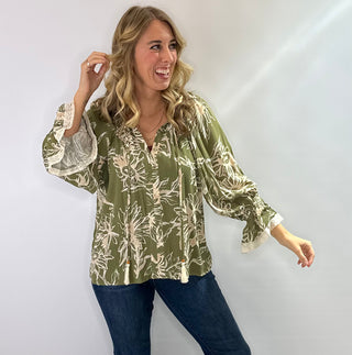 Floral printed 3/4 sleeve top with V-neck tassel tie, flutter lace trim sleeves, and flutter hem in olive/cream or burgundy/cream