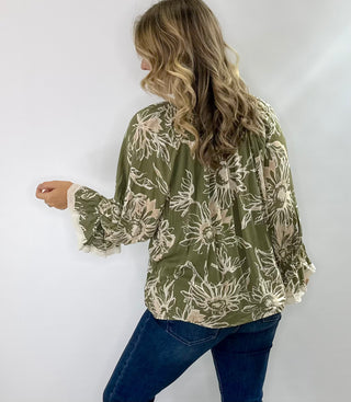 Floral printed 3/4 sleeve top with V-neck tassel tie, flutter lace trim sleeves, and flutter hem in olive/cream or burgundy/cream