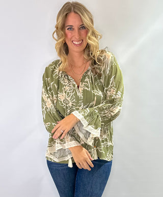 Floral printed 3/4 sleeve top with V-neck tassel tie, flutter lace trim sleeves, and flutter hem in olive/cream or burgundy/cream