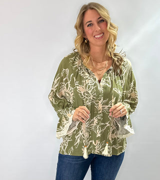 Floral printed 3/4 sleeve top with V-neck tassel tie, flutter lace trim sleeves, and flutter hem in olive/cream or burgundy/cream