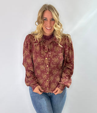 Burgundy knit top with gold floral pattern, vintage snap buttons, puff sleeves, and collar