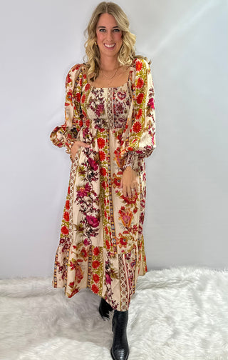 Cream and burgundy boho floral maxi dress with gathered sleeves and ruffle trim in a flowy silhouette