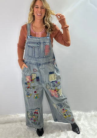 Blue Velvet Wildflower Roads Overalls in vintage-washed denim with boho embroidery, patchwork details, and oversized relaxed fit