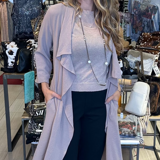 Light weight open front trench coat with pockets in taupe. Versatile tie to wear as a wrap dress