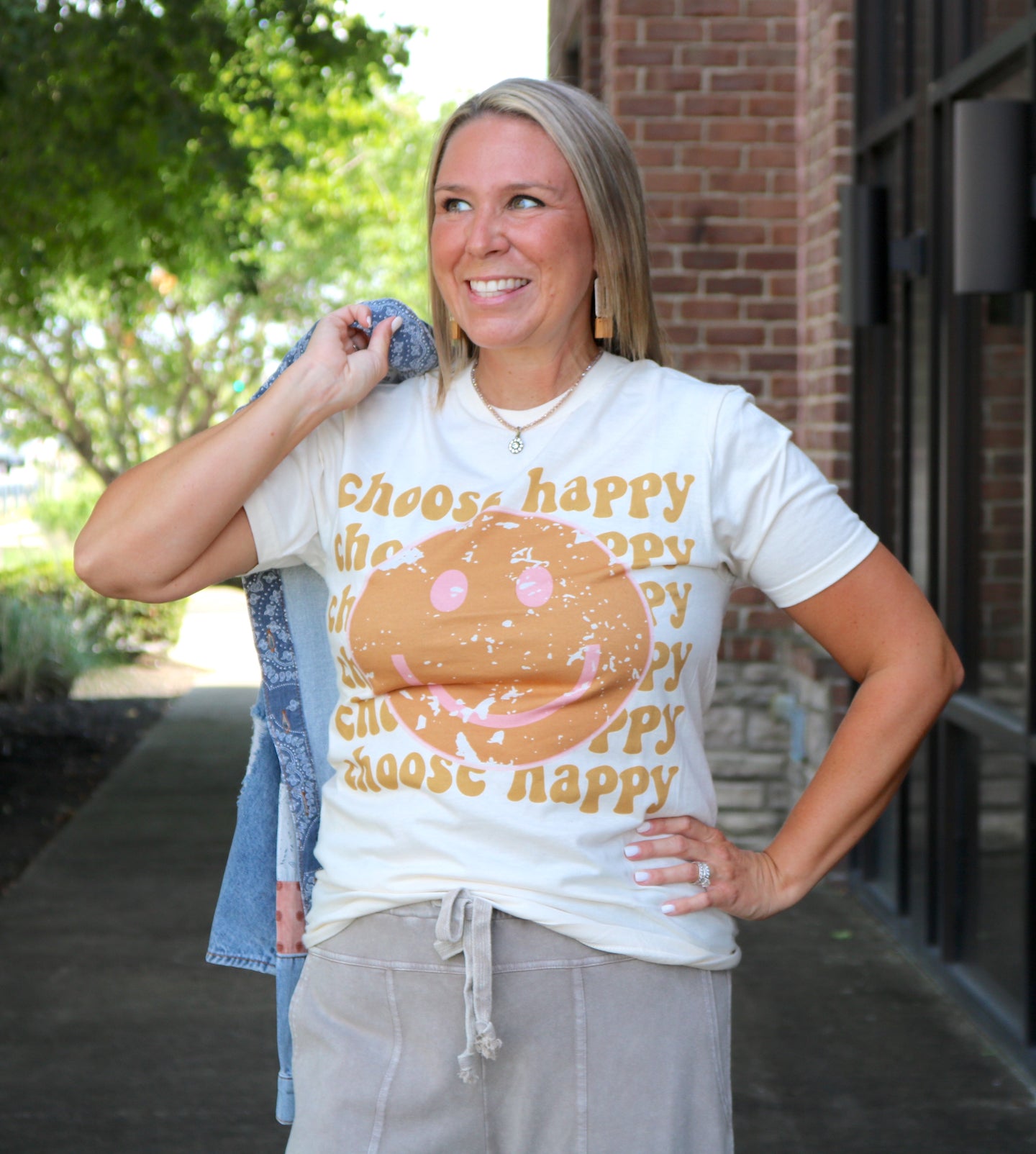 Smile Face Choose Happy Graphic Tee is an adorable and oh so soft Graphic tee in a neutral cream color with a gorgeous sunburst orange smile face and a pop of pink. We'll Choose Happy EVERY day in this tee!!
