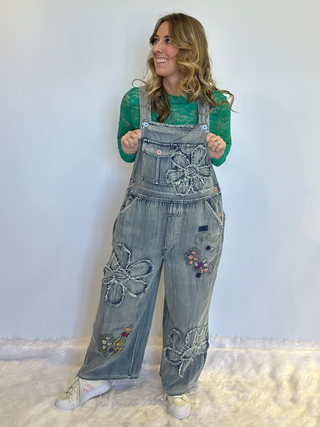 Flower Patchwork And Embroidered Denim Overalls with full length silhouette, adjustable button shoulder straps, side button closures, and functional bib pockets