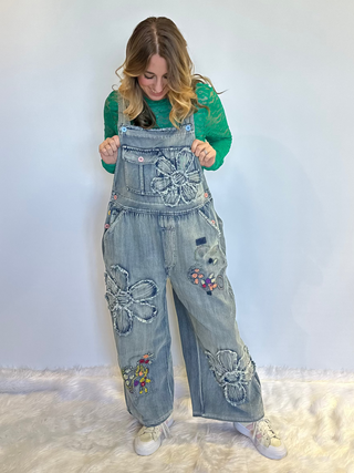 Flower Patchwork And Embroidered Denim Overalls with full length silhouette, adjustable button shoulder straps, side button closures, and functional bib pockets