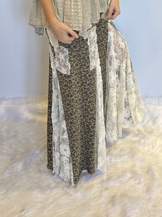 Taupe leopard print wide leg pants with lace and ruffle detailing, elastic waistband, full length exaggerated silhouette and side pockets