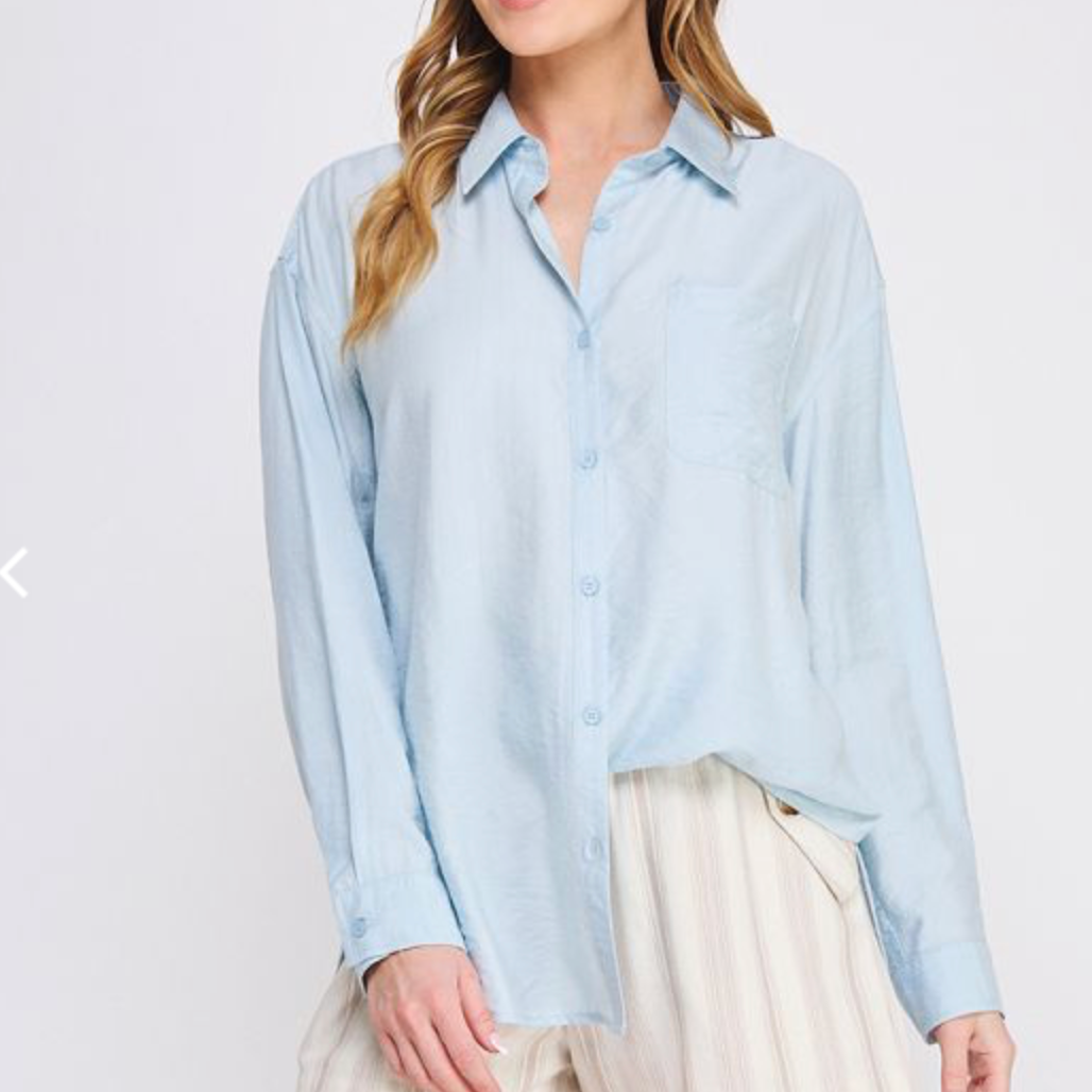 Blue cotton button front collared shirt with open back tie back. 
