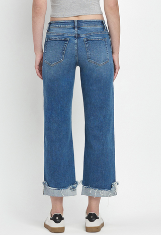 Mid-Rise slim wide-leg jean with a raw cuffed hem, light medium denim wash, relaxed structured fit by Flying Monkey