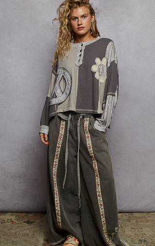 Gray French Terry Knit Oversized top with round neck balloon sleeves, ribbed cuffs and oversized peace sign floral patch with a button detail by Pol