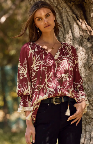 Floral printed 3/4 sleeve top with V-neck tassel tie, flutter lace trim sleeves, and flutter hem in olive/cream or burgundy/cream