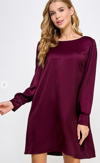 Plum Satin Shift Dress with long cuffed sleeves and scoop back box pleat details.