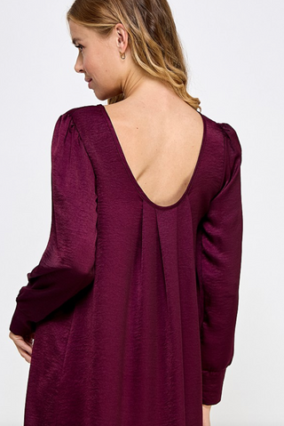 Plum Satin Shift Dress with long cuffed sleeves and scoop back box pleat details.