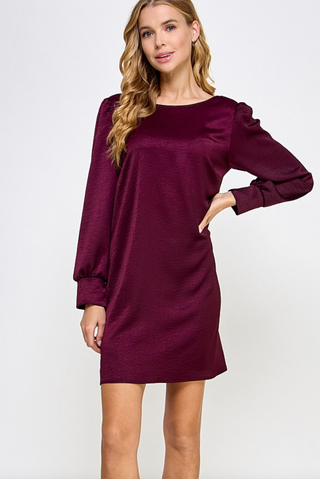 Plum Satin Shift Dress with long cuffed sleeves and scoop back box pleat details.
