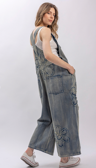 Flower Patchwork And Embroidered Denim Overalls with full length silhouette, adjustable button shoulder straps, side button closures, and functional bib pockets