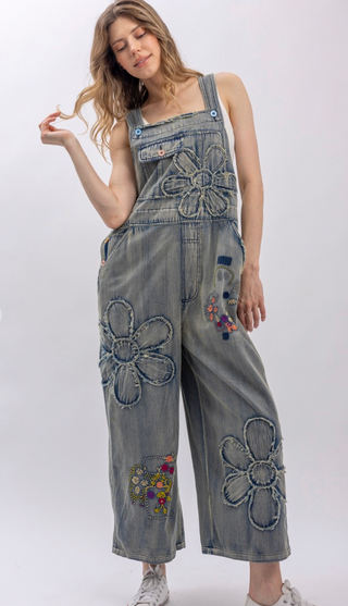 Flower Patchwork And Embroidered Denim Overalls with full length silhouette, adjustable button shoulder straps, side button closures, and functional bib pockets