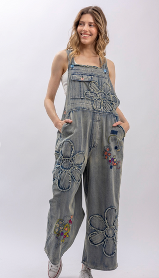 Flower Patchwork And Embroidered Denim Overalls with full length silhouette, adjustable button shoulder straps, side button closures, and functional bib pockets