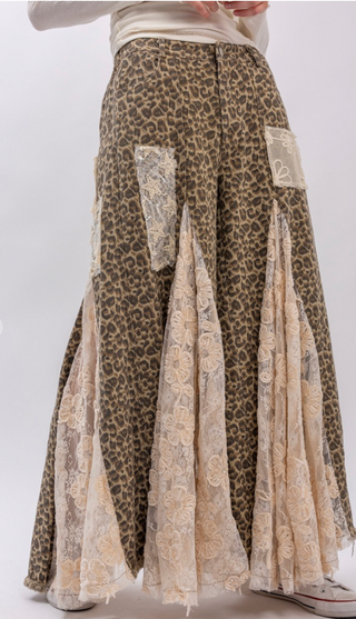 Taupe leopard print wide leg pants with lace and ruffle detailing, elastic waistband, full length exaggerated silhouette and side pockets
