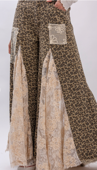 Taupe leopard print wide leg pants with lace and ruffle detailing, elastic waistband, full length exaggerated silhouette and side pockets
