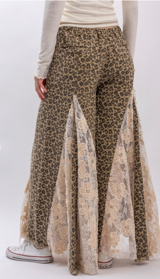 Taupe leopard print wide leg pants with lace and ruffle detailing, elastic waistband, full length exaggerated silhouette and side pockets