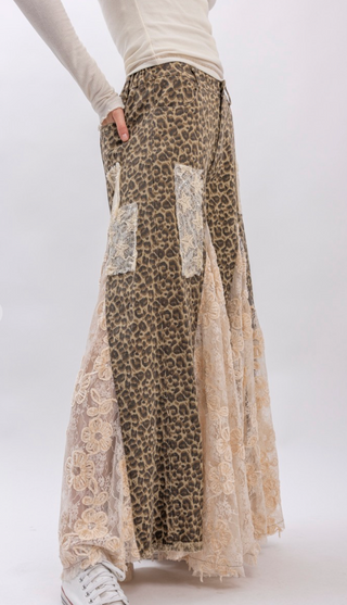 Taupe leopard print wide leg pants with lace and ruffle detailing, elastic waistband, full length exaggerated silhouette and side pockets