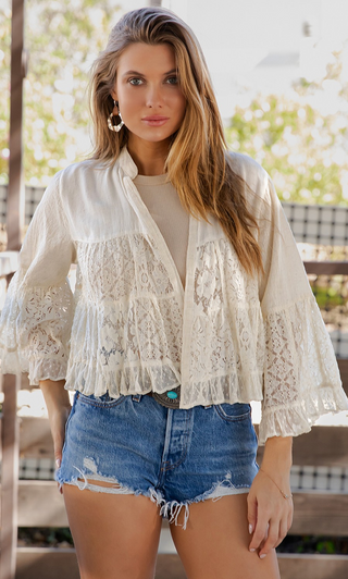 Cropped open front lace shrug with structured flax yoke, tiered lace body, and 3/4 ruffle bell sleeves in a lightweight boho style