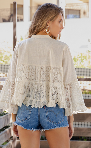 Cropped open front lace shrug with structured flax yoke, tiered lace body, and 3/4 ruffle bell sleeves in a lightweight boho style