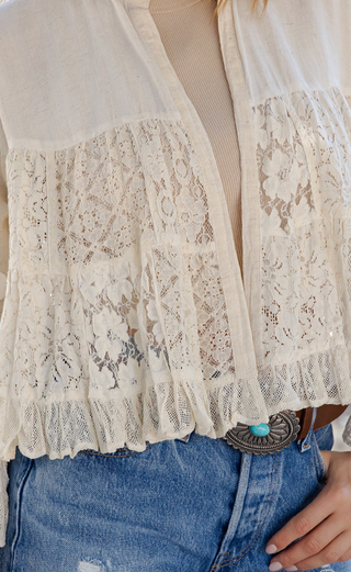 Cropped open front lace shrug with structured flax yoke, tiered lace body, and 3/4 ruffle bell sleeves in a lightweight boho style
